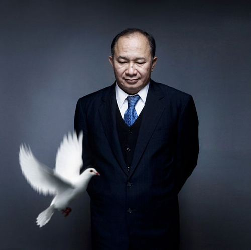John Woo releasing doves onto the set of his own photo shoot. Why? Because he's John Woo, that's why.